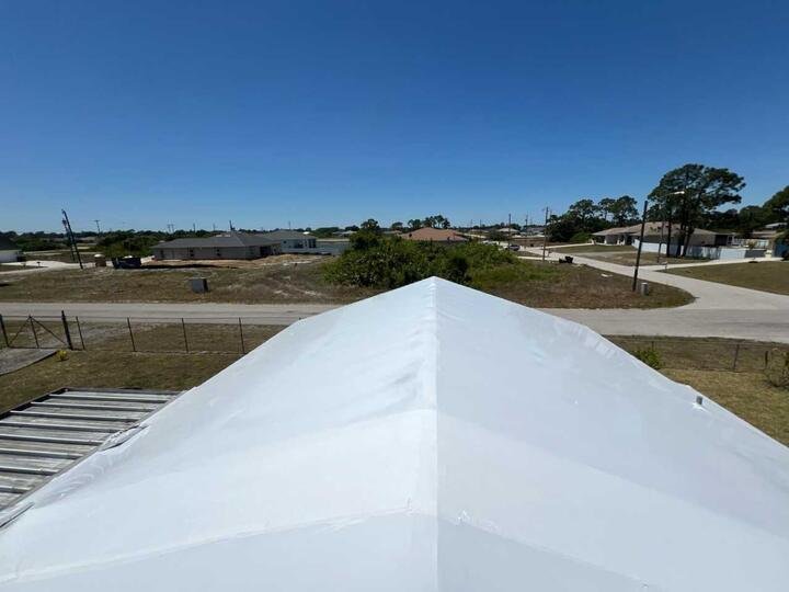 Roof covered with white shrink wrap