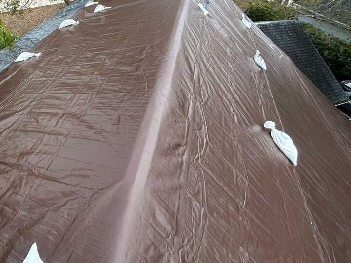 Roof covered with a brown emergency tarp