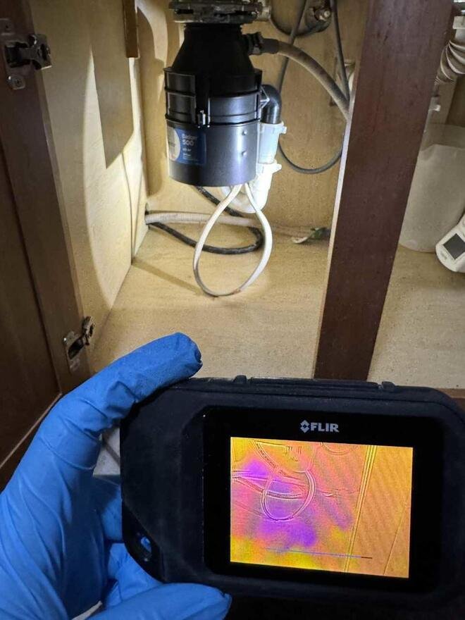Thermal camera showing moisture under a kitchen sink